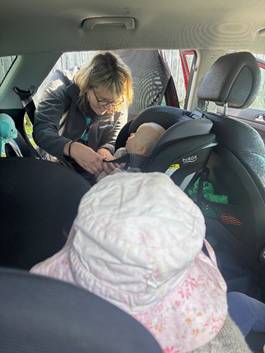 A person holding a baby in a car seat

AI-generated content may be incorrect.