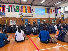 A group of people sitting on the floor in a classroom

AI-generated content may be incorrect.